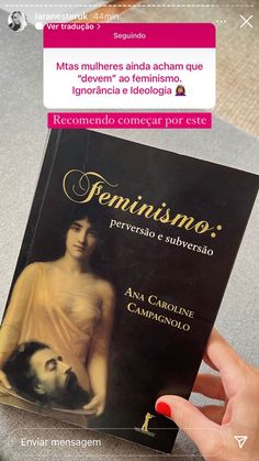 a person holding up a book with an image of a woman on the front cover