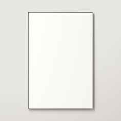 a white square frame hanging on the wall