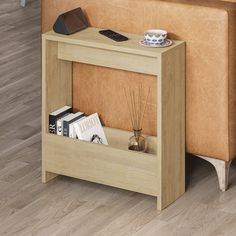 a white table with a book shelf on top of it next to a couch in a living room