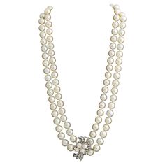 This double strand Pearl necklace is set with is set with a diamond and cultured pearl clasp in 14k white gold set with single cut diamonds .The cultured pearls are approximately 8 mm each and have a lovely cream body color and good luster with pink overtones. Diamonds are approximately a half carat in total. The necklace clasp is also marked 14k. This piece is in excellent vintage condition. Length 16 inches Weight 70 grams American circa 1950 Double Strand Pearl Necklace, Pearl Clasp, Double Strand Necklace, White Gold Set, Necklace Clasps, Body Colour, Body Cream, Cultured Pearls, White Gold Diamonds