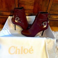 New Unworn Leather Chloe Booties. They Are A Rich Burgundy/Purple Color In Size 38.5 With A Heel Height Of Approximately 3.5 Inches And An Ankle Circumference Of Approximately 9 Inches. Very Chic And Stylish!!! They Will Be Shipped In The Original Shoe Box With The Original Shoe Dust Bag. Chic Burgundy Boots With Reinforced Heel, Chic Burgundy Heeled Boots With Round Toe, Chic Burgundy Ankle Heeled Boots, Chic Burgundy Ankle Boots, Chic Ankle Strap Boots, Chic Burgundy High Heel Boots, Chic Booties With Buckle Closure And Medium Width, Chic Boots With Heel Strap And Round Toe, Chic Ankle Strap Boots With Padded Heel