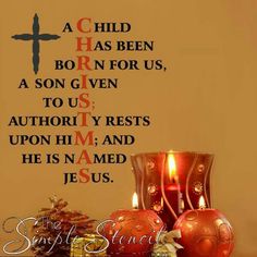 a wall decal with a cross and two candles in front of it that reads, a child has been born for us, a son given to us