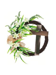 a wreath with white flowers and green leaves