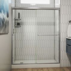 a bathroom with a walk in shower next to a sink