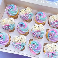 a box filled with cupcakes covered in frosting