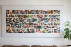 a wall hanging over a couch with pictures on the wall and a potted plant next to it