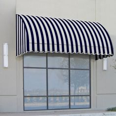 a black and white striped awning on the side of a building