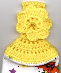 a crocheted yellow and white hat with stars on it