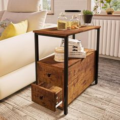 a living room with a white couch and wooden drawers on the floor next to a coffee table