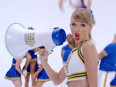 a cheerleader holding a megaphone in front of her face