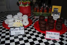 two red plates topped with donuts on top of a black and white checkered table cloth