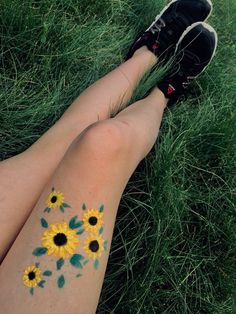 a person with sunflowers painted on their legs