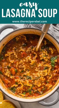 a large pot filled with pasta and spinach soup on top of a white counter