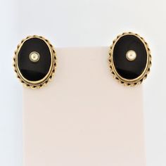 "60s Onyx And Pearl Oval Clip-on Earrings- 14k Yellow Gold  Metal:  14K Yellow Gold  Dimension: 0.8\" L x 0.5\" W  Stone Info:  Natural oval cabochon Onyx Natural south sea pearls Weight: 7.9 *More pictures available upon request.* We offer a risk free 30 - day return policy if you are not completely satisfied, you get your money back! If you are not happy for any reason, return for a full refund less shipping within 30 days.  Vintage items are unique, highly collective, may show light wear but Yellow Gold Oval Clip-on Earrings For Anniversary, 14k Gold Oval Earrings For Evening, Formal Oval Clip-on Earrings, Oval Evening Earrings, Classic Oval Earrings For Evening, Vintage Oval Earrings For Evening, Black Oval Earrings For Anniversary, Classic Oval Pierced Earrings, Oval Earrings With Polished Finish For Anniversary