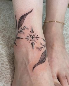 two people with tattoos on their feet and one has a flower tattoo on the foot