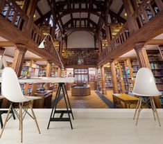 the interior of a library with chairs, tables and bookshelves full of books