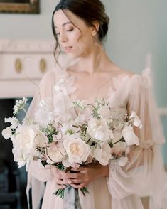 a woman holding a bouquet of flowers in her hands