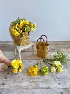 someone is arranging flowers in baskets on the table