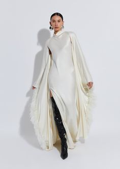 Doubleface satin floor length caftan with fitted long sleeves and no closure, with feathers. True to size. Material: 61% Acetate, 39% Viscose Trim: 100% Ostrich Feathers; Dyed Ostrich Feather, Struthio Camelus, Republic of South Africa Care: Clean By Fur Specialist Only Feathers Outfit, Cream Formal Dress, Casual Cape, Feather Gown, Fur Dress, Coctail Dresses, Ostrich Feather, Feather Dress, Old Hollywood Glamour