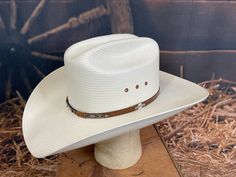 Made in the USA Straw material Cattleman crease 4 1/4' Brim Leather sweatband Eyelet vents along crown Outside leather band w/ small logo pin Sizes: 6 3/4" - 7 3/4" White Western Hat For Formal Occasions, White Western Formal Hat, White Rigid Hat For Ranch, Classic White Hat Bands For Rodeo, Classic White Hat Band For Rodeo, White Flat Brim Hat With Rigid Fit, White Rigid Flat Brim Hat, White Country Hat With Flat Crown, Classic High Crown Hat Bands For Ranch