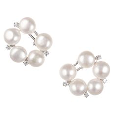 Circular clip post fresh water pearl and round diamond clip post earrings set in 18k white gold. 10 fresh water fine white cultured pearls, 11 x 7.5mm, excellent lustre and few blemishes 8 round full cut diamonds, approx. total weight .62cts, G, VS 18k white gold Tested: 18k Stamped: 750 24.0 grams Diameter: 28.84mm or 1.13 inches Depth: 10mm Diamond Tops, Mabe Pearl, Baroque Pearl Earrings, Gold Clips, Freshwater Pearls Earrings, Fresh Water Pearl, White Gold Earrings, Baroque Pearls, Cultured Pearls