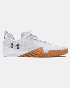 the under armour shoes are white and brown