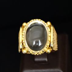 Capture a beautiful moment with this 18K yellow gold plated sterling silver crystal quartz ring. Handmade with natural Durr Al Najaf gemstone, this unique jewelry is a daring addition to your collection. Size 10, but can be resized. Metal: 925k Sterling Silver (18k gold plated) Gemstone: Crystal Quartz also known as Durr al-Najaf Dimensions of the stone: 15x20mm Size: US 10 Durr Al Najaf is a glossy and clear gemstone from the quartz family. The name means "pearl of Najaf" as it can only be sour Luxury Citrine Cabochon Jewelry, Elegant Gold Crystal Ring With Cabochon, Elegant Gold Moonstone Cabochon Ring, Luxury Yellow Gold Crystal Ring With Gemstone, Exquisite Gold Ring With Stone Setting, Exquisite Gold Rings With Stone Setting, Gold Cabochon Crystal Ring For Anniversary, Luxury Gold Moonstone Ring For Formal Events, Heirloom Gold Moonstone Ring For Formal Events