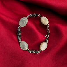 This bracelet features stunning Mother of Pearl and faceted onyx beads accented with intricate Silver Bali beads. It measures 7 inches in length. Elegant Silver Beaded Bracelet With Oval Beads, Elegant Handmade Bracelets With Oval Beads, Elegant Adjustable Bracelet With Oval Beads, Elegant Adjustable Bracelets With Oval Beads, Elegant Adjustable Oval Beads Bracelets, Elegant Adjustable Oval Beads Bracelet, Elegant Agate Jewelry With Oval Beads, Elegant Silver Gemstone Beads, Elegant Oval Bead Agate Jewelry