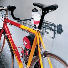 a yellow bicycle parked in front of a white house next to a red and yellow bike