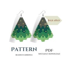 a pair of earrings with green trees on them and the words pattern printed in white