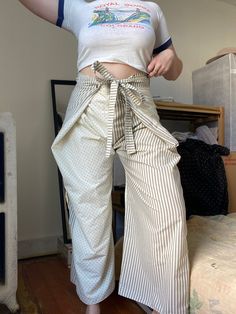 "Unique & one of a kind pants. Only worn a few times. Can be worn fastened in front or back.  Waist: 16 Rise: 16 Hip: flexible depending on desired fit (shown on 42\" hip) Inseam:25.5" Cotton Pants With Tie Waist, Fitted Wide Leg Parachute Pants For Spring, Fitted Wide Leg Harem Pants With Belt Loops, Relaxed Fit Tie Waist Long Bottoms, Relaxed Fit Cotton Bottoms With Tie Waist, Relaxed Fit Bottoms With Tie Waist, Fitted Cotton Parachute Pants, Fitted Straight Leg Cotton Harem Pants, Fitted Wide Leg Pants With Tie Waist