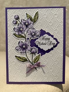 a close up of a card with flowers on the front and purple trimmings