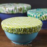 three blue bowls with green and white designs on them sitting on a wooden table next to each other