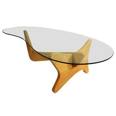 an oval glass table with wooden legs and a wood base, on a white background