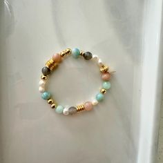 This fresh water pearl and mixed gemstone beaded bracelet features a  mix of 18K gold-filled beads with a fun mix of pastel shades of light greens and peach natural gemstone beads. It is the perfect bracelet to wear alone or add to your bracelet stack. It will make as a great gift to others and even yourself!  Materials: This bracelet features a mixed array of all natural healing gemstones with dainty freshy water pearls and is finished with 18K gold filled hardware.  Gemstones: Aquamarine, Larimar, Sunstone *Please note due to the unique coloring of each gemstone, the colors and variation of your piece may differe slightly from what is shown in the listing photos. Sizing: Standard size 7" - This size fits most! If another size is needed, please note before check out. *Please note exchange Gold Beaded Bracelets With Pearl And Gemstone Beads, Gold Pearl Bracelets With Gemstone Beads, Multicolor Pearl Bracelet With Gemstone Beads, Pearl Beaded Bracelets With Natural Stones, Natural Stone Pearl Beaded Bracelets, Healing Pearl Bracelet With Round Beads, Healing Pearl Bracelet With Natural Round Beads, Candy Bracelet, Healing Gemstones