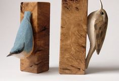 two wooden blocks with birds on them, one blue and the other brown in color