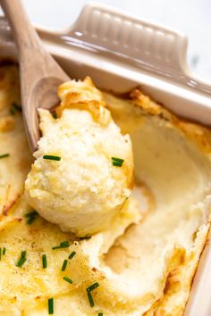 a dish with mashed potatoes and a wooden spoon