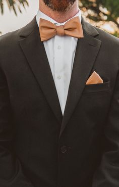 a man wearing a suit and bow tie