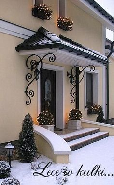 a house covered in snow and decorated for christmas