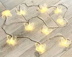 a string of fairy lights sitting on top of a wooden floor