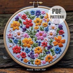 an embroidery pattern with colorful flowers in the center on a wooden surface and text overlay that reads, punch craft pdf