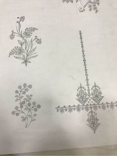 some drawings on paper with flowers and vines