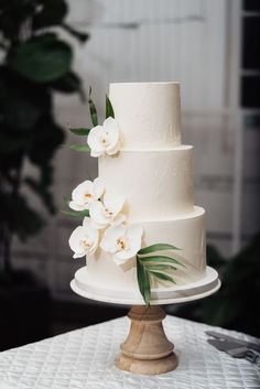 a wedding cake with white flowers on top