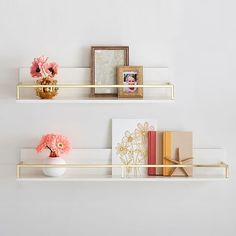 two shelves with flowers, books and pictures on them are featured in the same photo