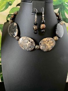 You will receive an unbelievably beautiful, black fossil coral, free-form, focal beaded necklace with earrings. These fantastic focal beads are strung with black fossil coral beads. No joke! This necklace is gorgeous Fossil coral is formed when, over millions of years, agate deposits fossilize the coral's skeletons.  Amazing, right?  I've tried to zoom in on each of the focals to show the amazing fossil markings.   This stunning, eye-catcher makes quite a statement! I use a toggle clasp making i Black Beaded Agate Jewelry, Black Beaded Jewelry With Oval Beads, Bohemian Onyx Round Bead Jewelry, Black Oval Gemstone Beads Jewelry, Costume Jewelry With Round Beads And Stones, Black Jewelry With Faceted Oval Beads, Black Jewelry With Oval Faceted Beads, Black Natural Stones Beads For Jewelry Making, Black Natural Stones For Jewelry Making