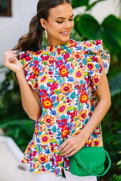 This bold blouse is stunning! It's going to look so fabulous this spring or summer! This blouse has a white background which makes those colorful flowers really pop! This blouse is going to look amazing with white jeans! This blouse features a high neckline, ruffled cap sleeves, a ruffled hemline, and a colorful floral print. Material has no amount of stretch.Sydney is wearing the small. Blouses Business Casual, Floral Print Dresses, Cute Tops For Women, White Floral Blouse, Beach Vacation Outfits, Floral Cocktail Dress, Shop Boutique, Black Tie Dress, Mint Julep Boutique