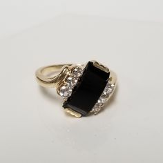 "Thanks for shopping our vintage estate store. We tend to sell well below wholesale and truly hope you enjoy all of our items. Many of the items are one of a kind, so please enjoy scrolling through the pictures and hopefully something will catch your eye. Beautiful vintage estate 10k yellow white gold black 3ct onyx .20ct CZ diamond cocktail ring. Retails $799 on sale $199 Ring size: 6.5 Setting: 1/2\" Band width: 2mm Weight: 3.07 grams Sweet ring, one that you will love. Marked 10k." Classic Black Rings For Anniversary, Black Channel Set Rings For Anniversary, Anniversary Black Channel Set Rings, Vintage Black Diamond Round Ring, Vintage Cluster Ring With Accent Stones For Formal Occasions, Vintage Black Round Diamond Ring, Classic Black Diamond Ring Stamped 14k, Classic Hallmarked Black Diamond Ring, Classic Black Hallmarked Diamond Ring