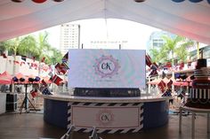 an outdoor event with flags and decorations on the ground, in front of a tent