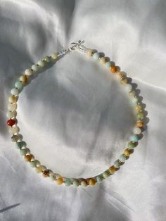 This cutie necklace is 15 inches long!! Please message us if you have any questions, we'll be happy to help Round Beads Necklace, Neutral Beaded Necklace, Single Strand Amazonite Spiritual Beaded Necklace, Amazonite Round Beads Necklace For Gift, Single Strand Amazonite Beaded Necklaces As Gift, Beaded Amazonite Crystal Necklace For Gift, Handmade White Amazonite Necklace, Gift Amazonite Single Strand Beaded Necklace, Amazonite Gemstone Beads Necklace As Gift