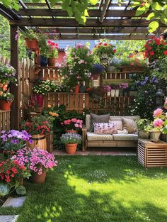 a garden with lots of potted plants and flowers